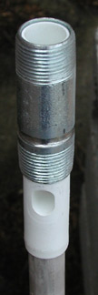 The top end of a combo magnesium anode, showing its plastic-lined steel nipple